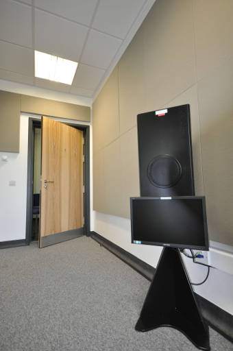 Listening booth with door ajar and speakers