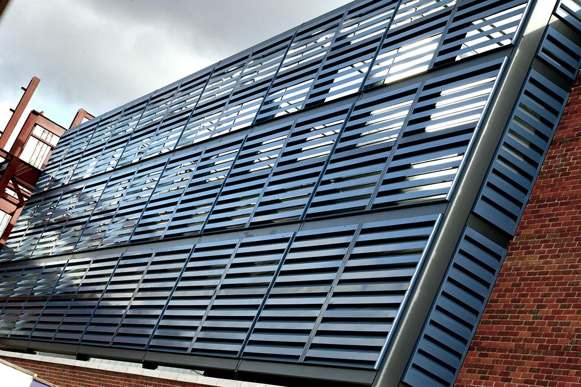 Acoustic cladding (Louvers) for reducing noise, installed at a parking garage