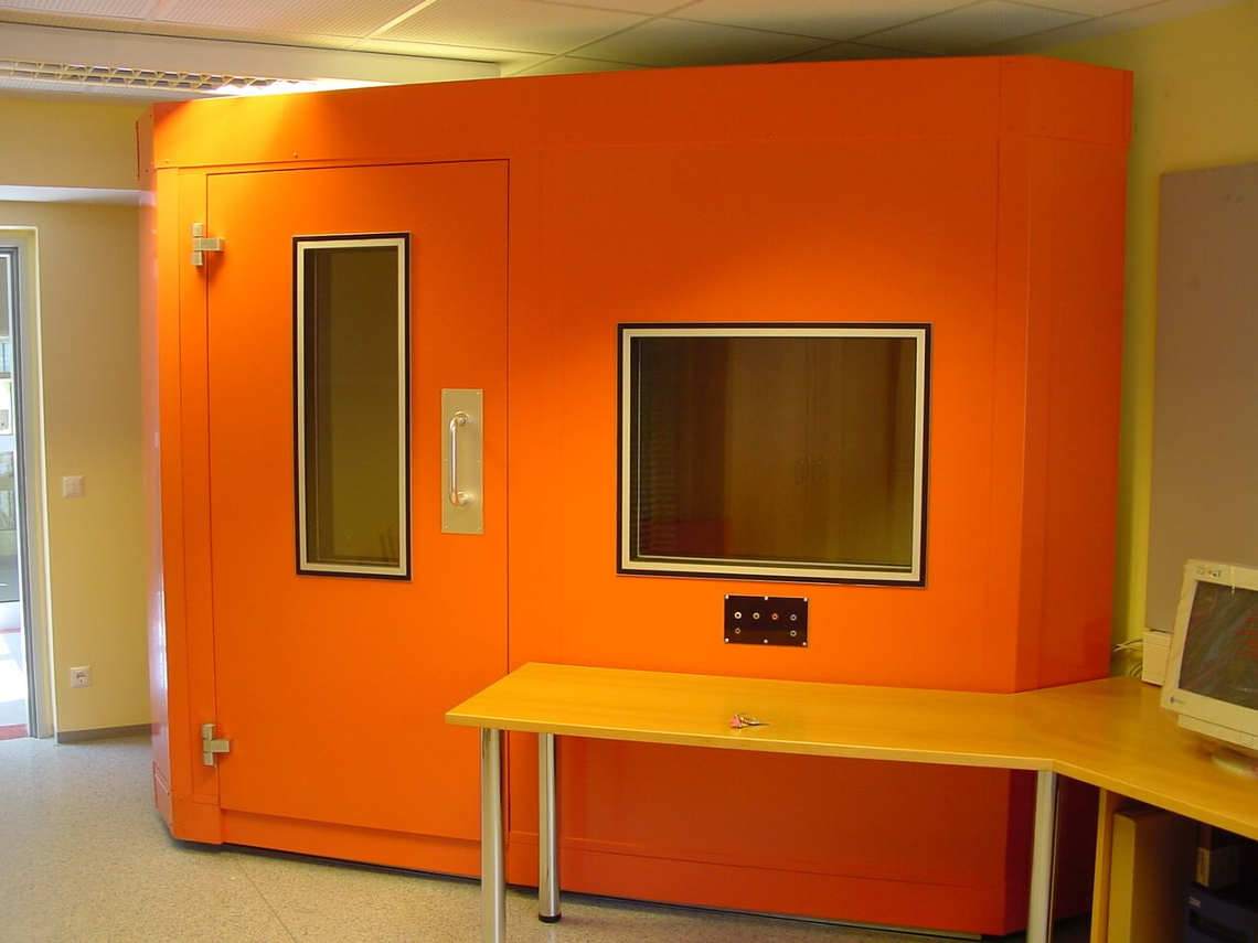 triangular orange audiometric sound room in the corner of the room