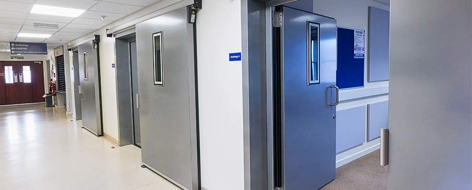 Soundproof door with an additional inserted soundproof sliding door in front of it