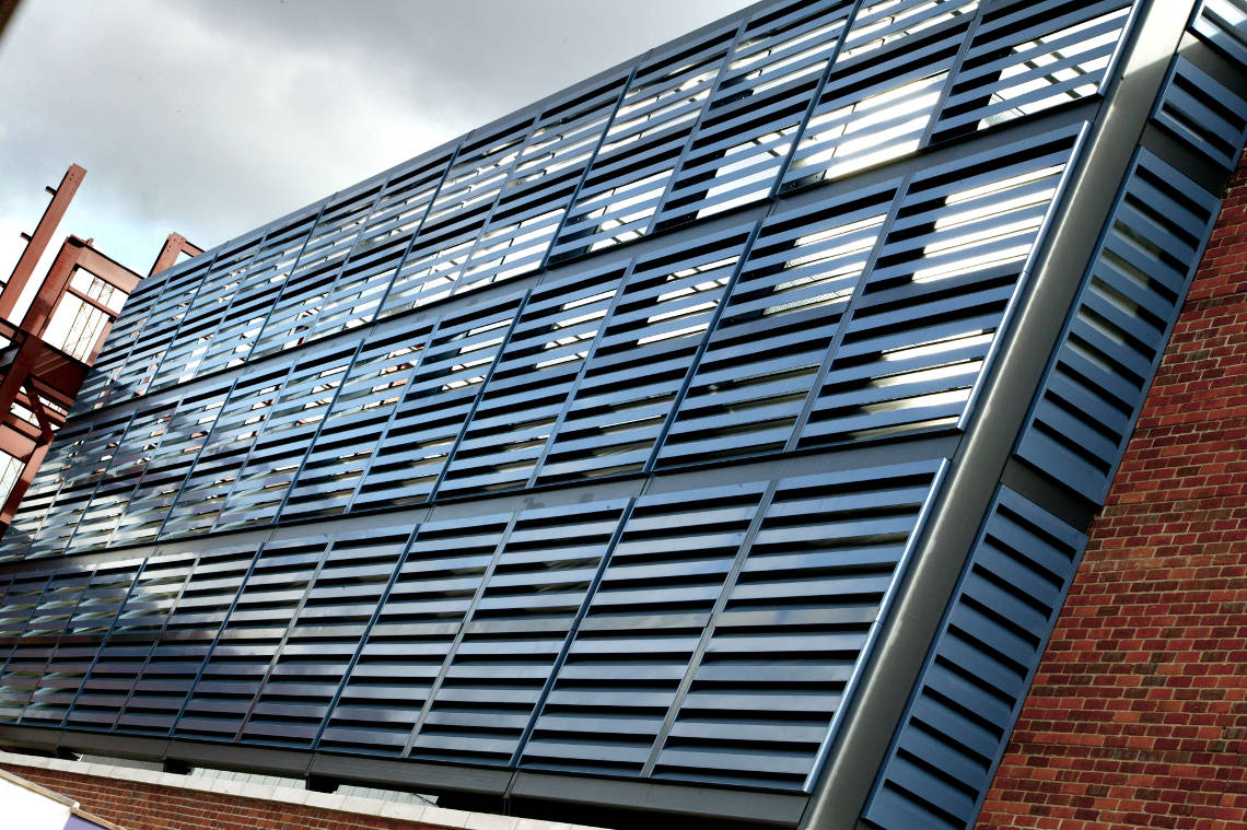 Acoustic cladding (Louvers) for reducing noise, installed at a parking garage
